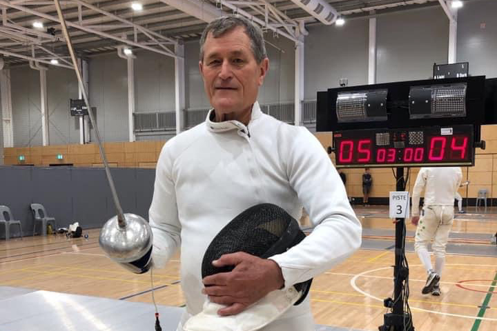 AFF Life Member Duncan Fairweather Duncan Fairweather in whites with epee and mask