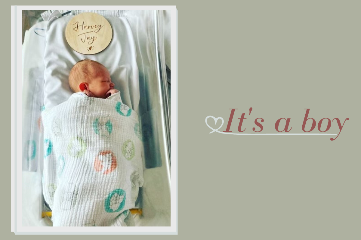 Photo of newborn baby asleep in crib with words 'it's a boy'