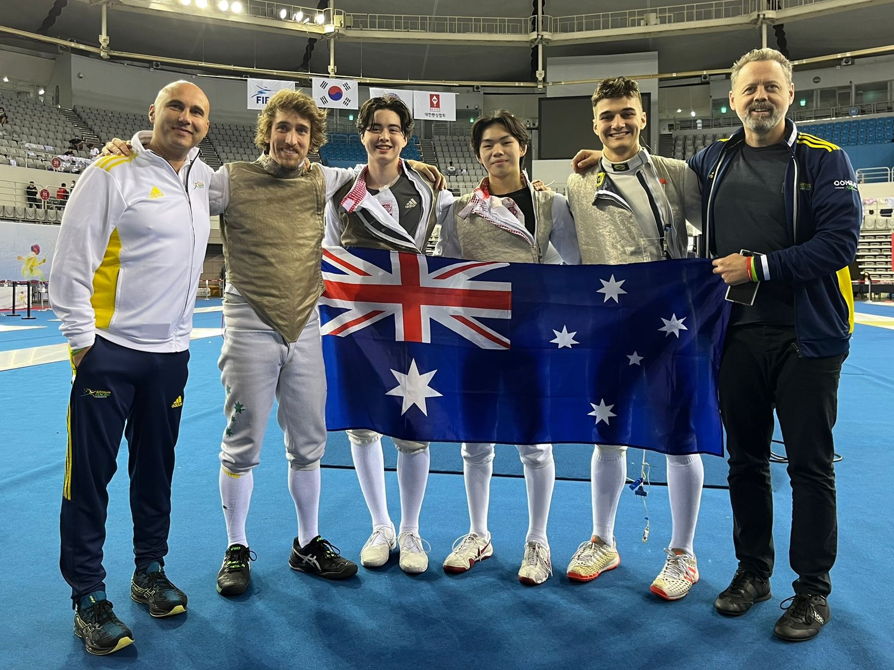 MFT with flag Group of fencing athletes holding an Australian flag