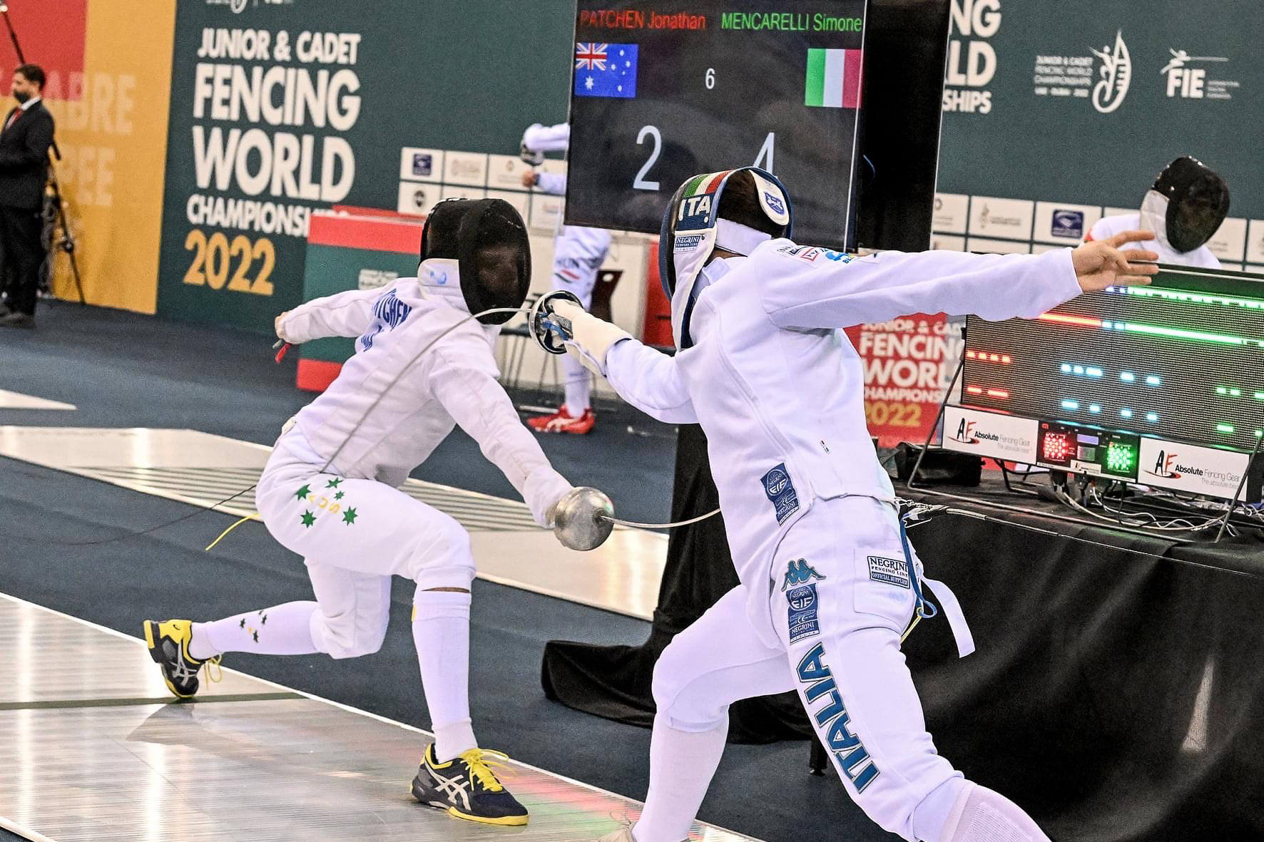 Two fencers competing on a piste in epee